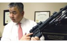Due Tran, a lawyer and NRA-certified instructor, teaches others about the different parts of a rifle.