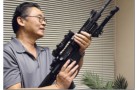 Cang Nguyen demonstrates how to hold an assault rifle in Due Tran’s conference room, where he holds gun education classes, in Falls Church, Va.