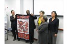 From l-r, Chinese delegation member Lu Yang presented Baltimore County Department of Planning officials with a dragon flag, Division Chief Dave Green, Division Chief Lynn Lanham and Deputy Director Liz Glenn, and Kui Zhao. 