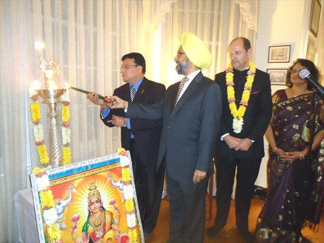 Representatives of the Hindu, Sikh and Jain faiths light the ‘diya’ (lamp) at the Diwali celebration in the residence of Barton (third from left) in D.C.