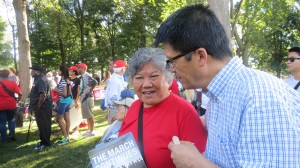 Lanfu Wei, a resident of the Wah Luck House in Northwest D.C., discusses with an interpreter why she attended the District’s rally for statehood on Aug. 24. The rally coincided with the 50th commemorative March on Washington for Jobs and Freedom. PHOTO CREDIT: Michelle Phipps Evans