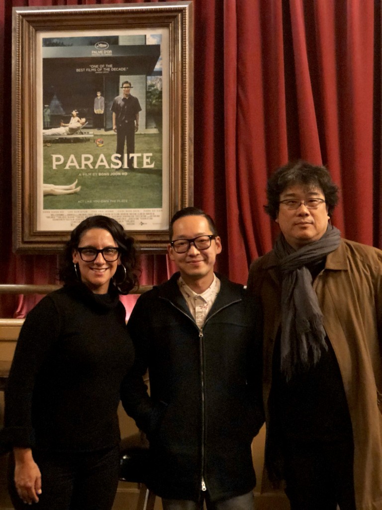“Parasite” director Bong Joon-ho (far right) and his translator Sharon Choi pose with Masashi Niwano, Festival and Exhibitions Director of Center for Asian American Media (CAAM).